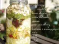 Słoik z warstwami składników do oxymelu: jabłko, chrzan, natka, czosnek, anyż, kurkuma, imbir, chilli, cebula.